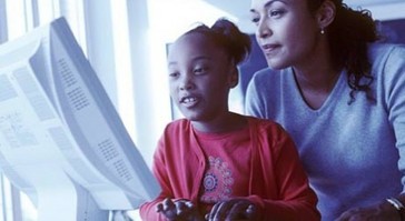 a girl and her mom on the computer